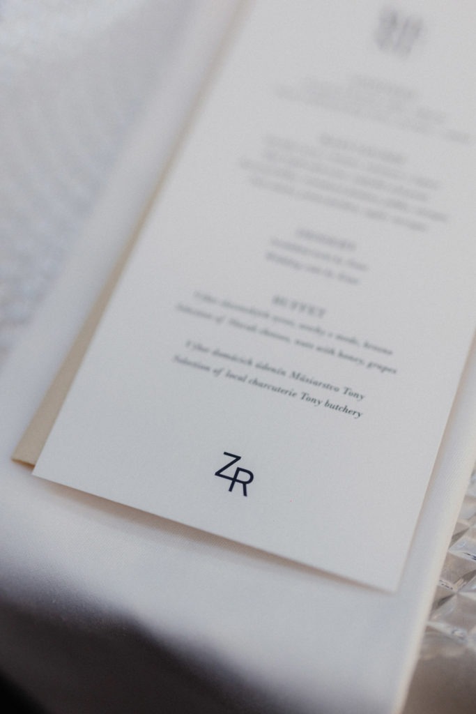 A wedding menu with a monogram on it.