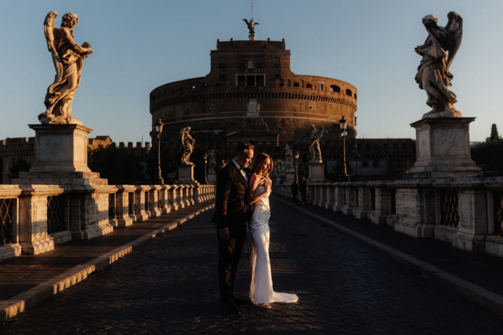 Stylish wedding couple in front of Saint Angel Castle at Sunrise