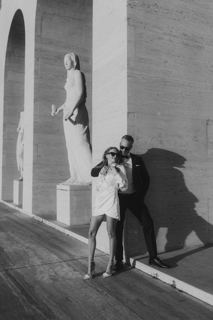 Wedding couple hugging in front of minimalism architecture in Rome