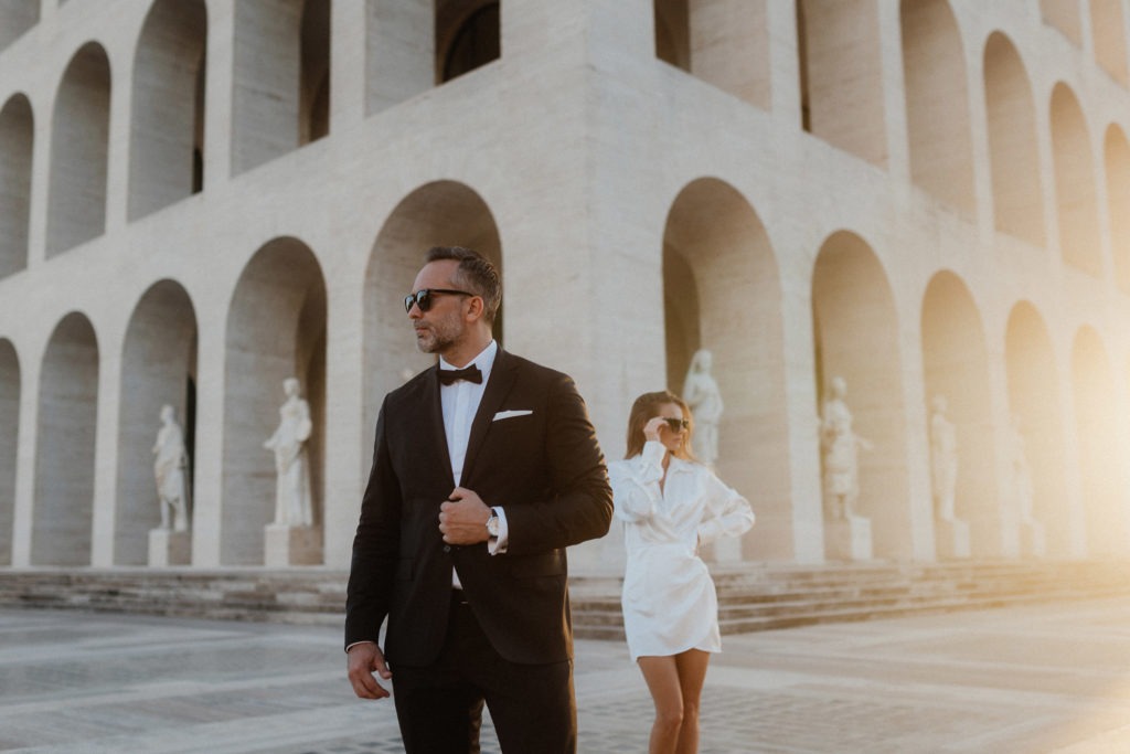 Wedding couple standing in front of minimalism architecture in Rome