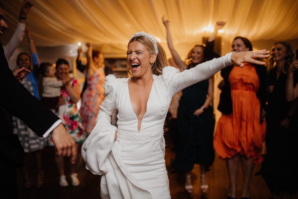 A bride is dancing on the dance floor at her wedding.