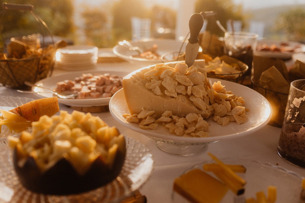 A table full of cheese, crackers, and other snacks.