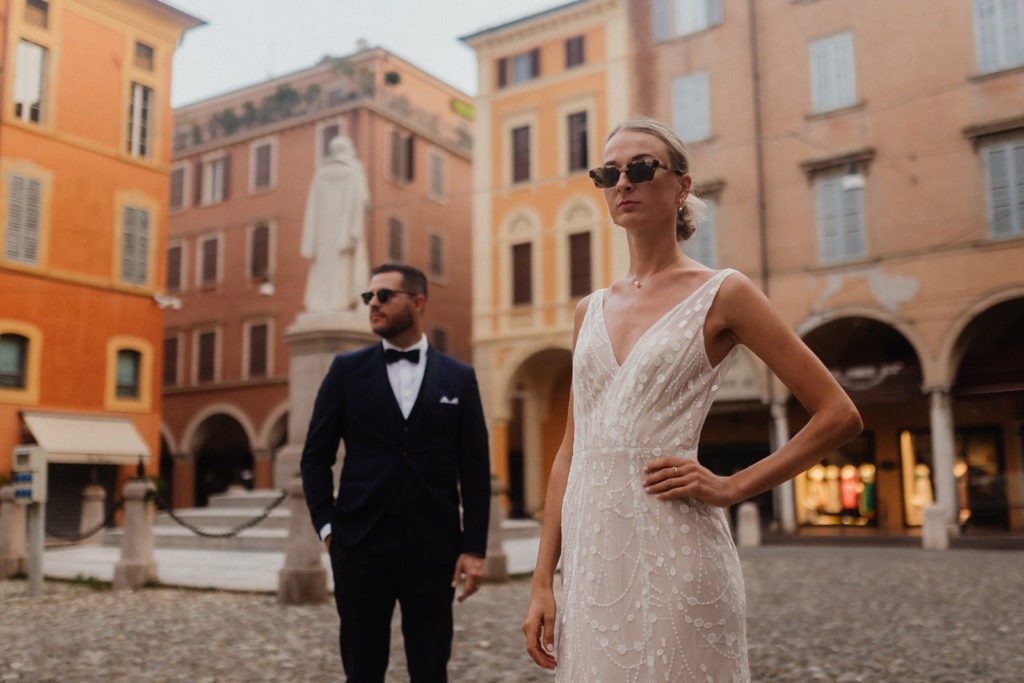 Stylish modern wedding couple wearing sunglasses in the streets of Modena Italy