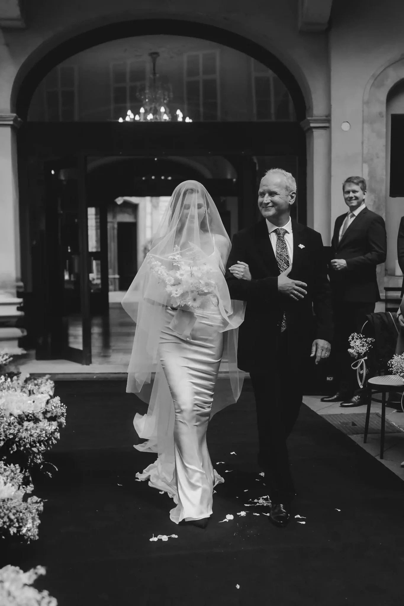 A bride walking down the aisle with her father.