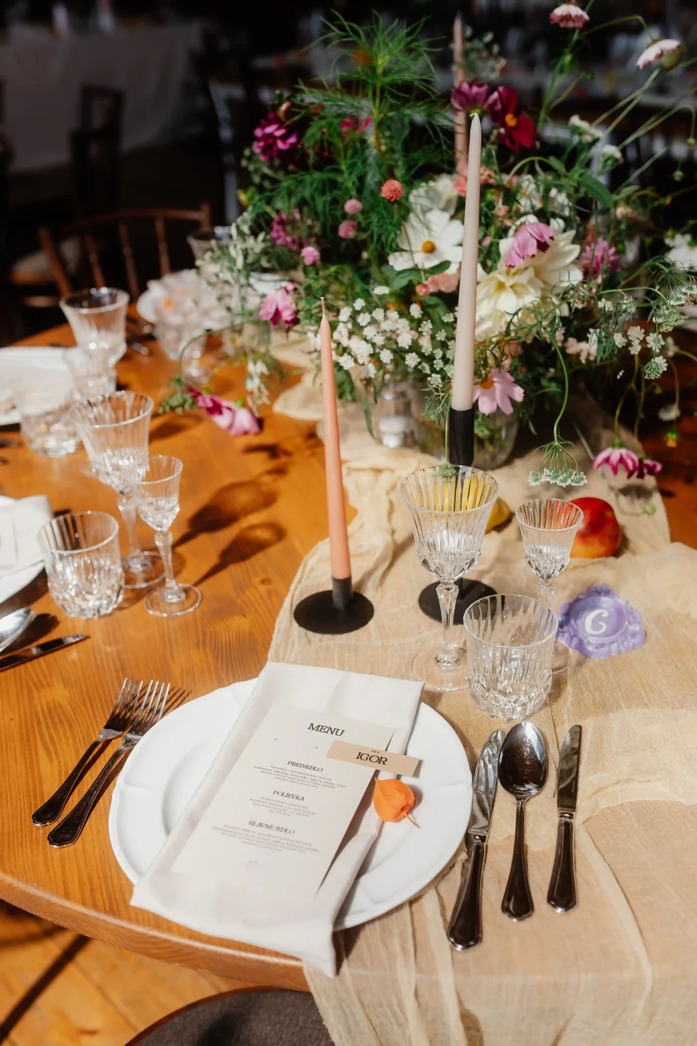 A table setting with flowers and place settings.