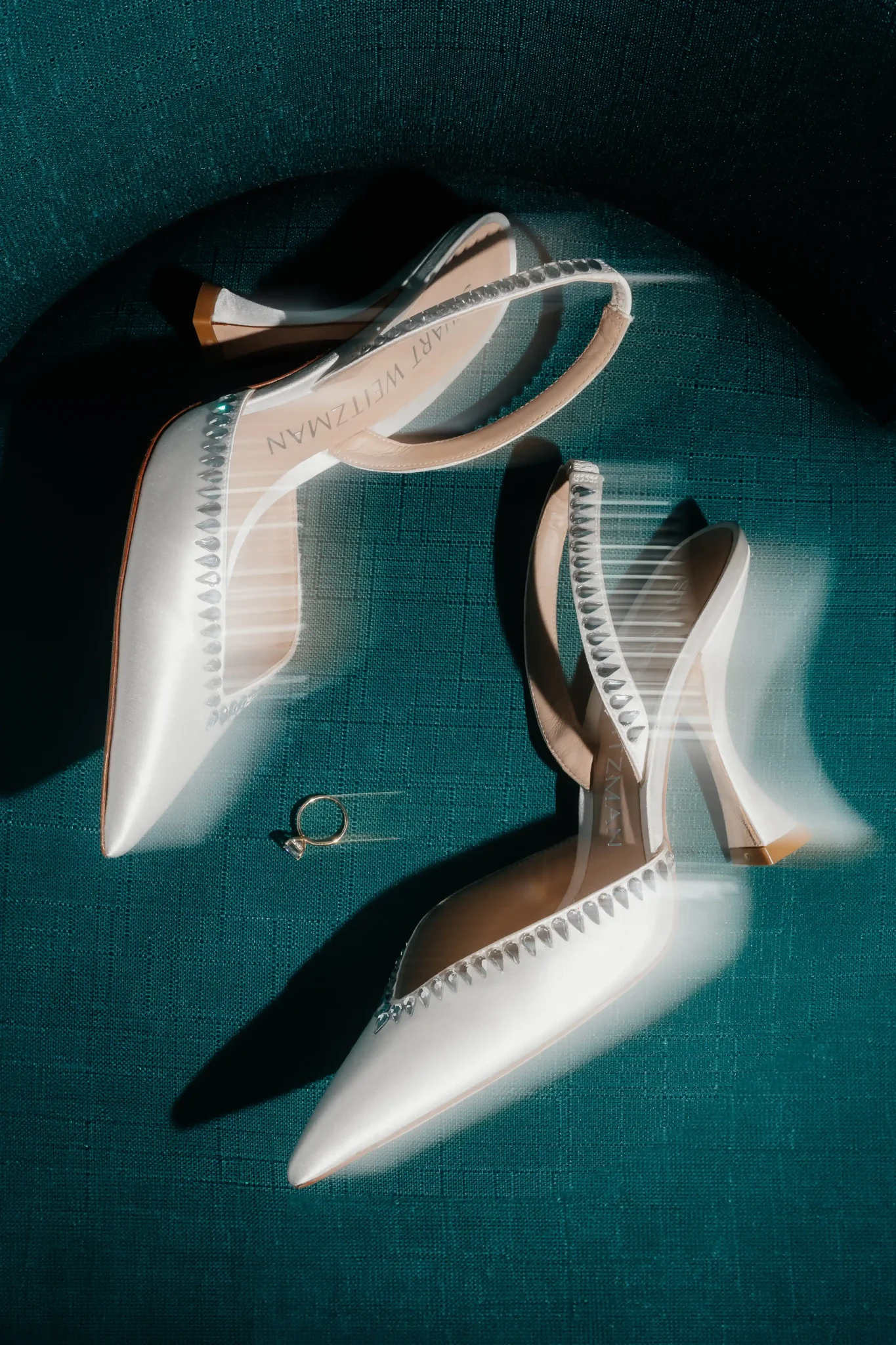 A pair of white shoes and a pair of earrings.
