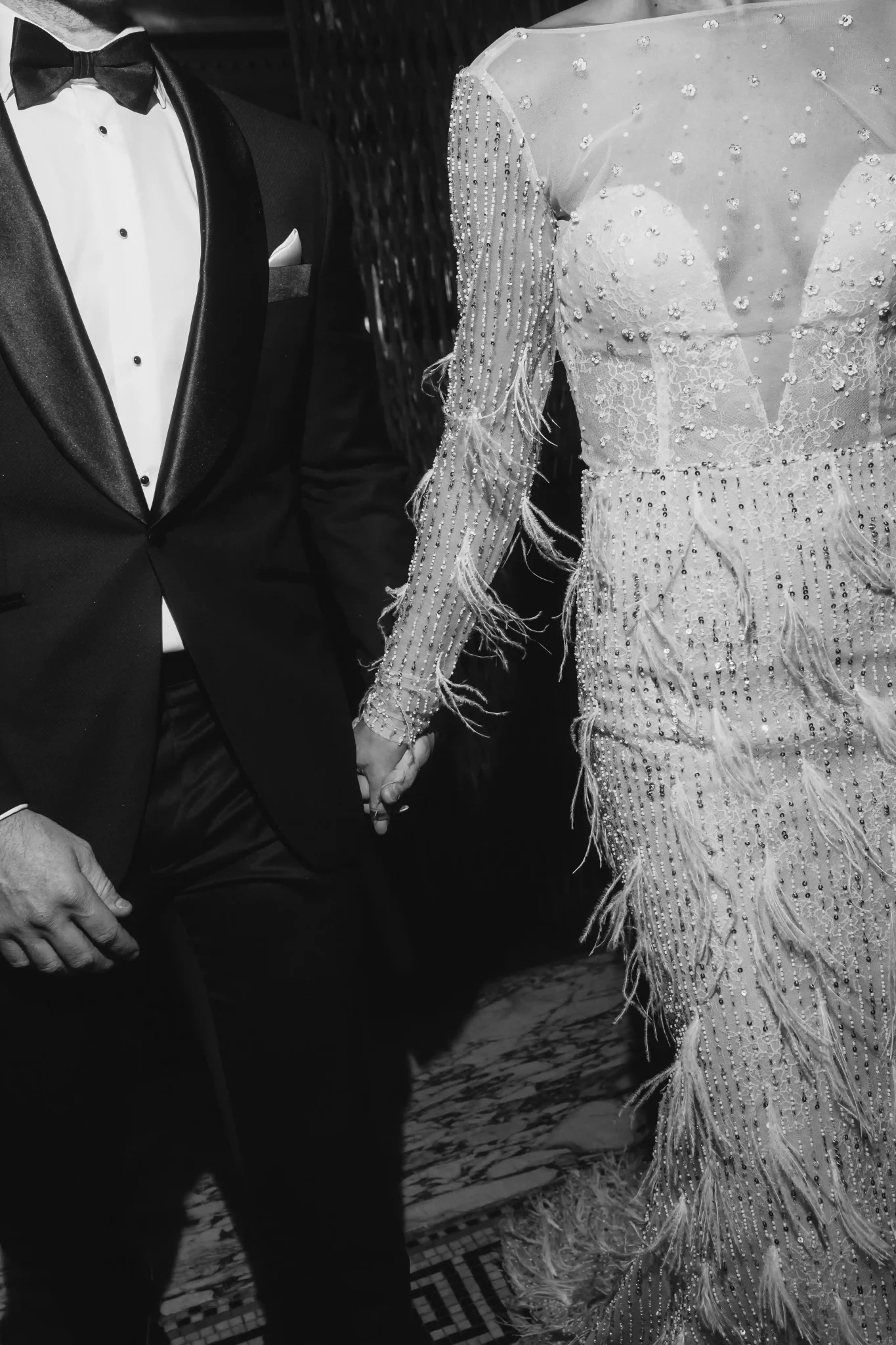 A black and white photo of a man and woman in a tuxedo.